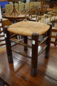 Liberty & Co, an oak and rush seated stool.