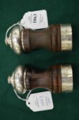 A pair of silver mounted salt and pepper grinders.