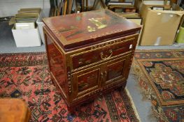 A decorative Chinese small cabinet with a drawer and pair of cupboard doors with chinoiserie