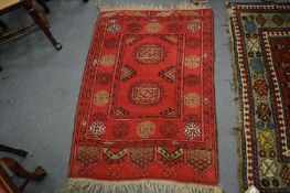 A small Persian style rug, 115cm x 83cm.