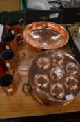 A copper twin handled mould, copper straining bowl and a graduated set of four measures.