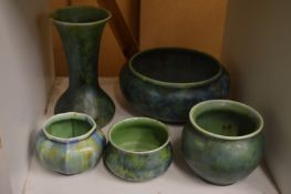 A collection of Clews & Co Chameleon Ware china to include four bowls and a vase.