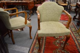 A pair of walnut framed open armchairs.