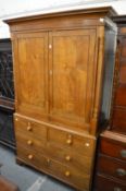 A good 19th century oak linen press with pair of doors flanked by column supports over two short and