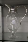 A silver mounted glass claret jug.
