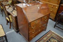 A George III mahogany bureau, the interior with partial inlaid decoration.