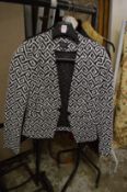 A ladies black and white evening jacket.