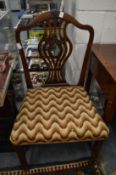 A Georgian style mahogany dining chair and a pair of Victorian carved walnut chairs.