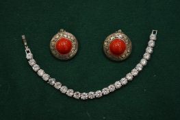 A pair of silver and coral earrings and a diamante bracelet.