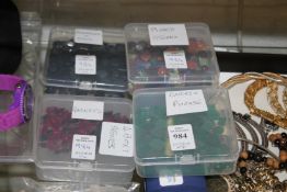 Four boxes of coloured stones.