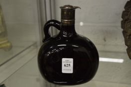 A white metal mounted amber colour glass jug.