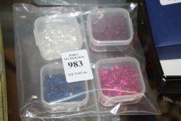 Four boxes of coloured spinels.