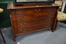 A good Arts and Crafts mahogany chest of drawers with a central frieze drawer flanked by a pair