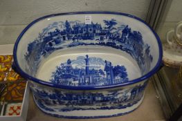 A large blue and white reproduction foot bath.