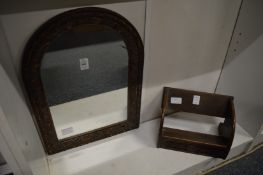 A small arch shaped mirror with carved wood frame together with a small book rest.