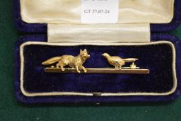 A good 18ct gold fox and pheasant bar brooch.