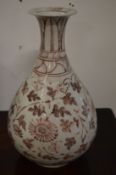 A Chinese bulbous shaped vase painted with flowers.