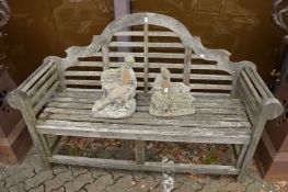 A Lutyens style hardwood garden bench.