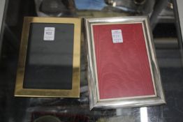 A silver photograph frame and a plated frame.