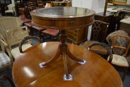 A reproduction mahogany drum table.