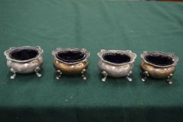 A set of four silver salts with blue glass liners (21).