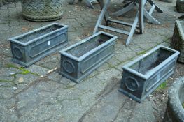 Three faux lead rectangular shaped garden planters.