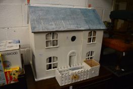 A painted dolls house with accessories.