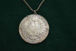 A 1780 coin in mount with chain.