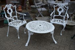 A pair of white painted aluminium garden chairs and a similar circular coffee table.