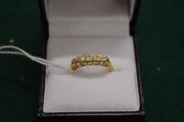 An 18ct gold and diamond five stone ring, size L½.
