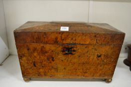 A burr wood sarcophagus shaped tea caddy.