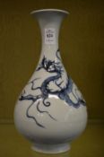 Large Chinese blue and white baluster shaped vase decorated with dragons.