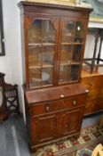 A reproduction mahogany secretaire cupboard bookcase.