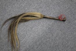 A carved dogs head handled fly-whisk.