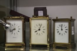 Three carriage clocks and a carriage clock case.