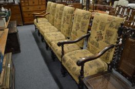A set of six walnut framed and upholstered dining chairs.
