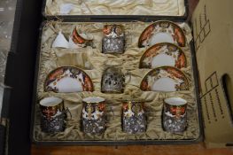 Part set of Royal Crown Derby Demitasse coffee cups and saucers with silver holders.