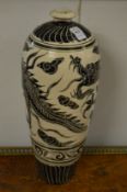 A Chinese tall pottery vase with incised dragon decoration.