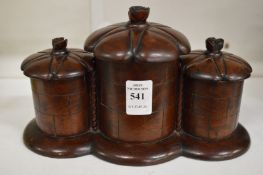 A carved wood three section tobacco jar.