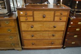 A Shoolbred & Co mahogany chest of drawers with a central deep drawer flanked by four small