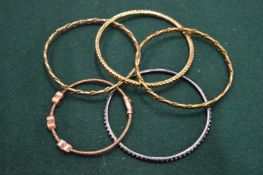 Five assorted bangles.