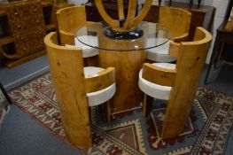 A good Art Deco style dining suite comprising a pedestal glass top table with a set of four burr