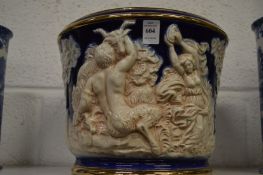 A large jardiniere embossed with playful classical figures.