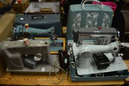 Four vintage sewing machines.