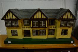 A Tri-ang dolls house with numerous accessories.