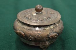 An Eastern white metal bowl and cover with embossed decoration (16).