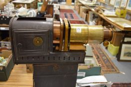 An early brass and black japanned projector in original case.