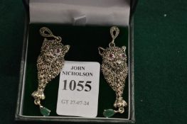 A pair of panther earrings.
