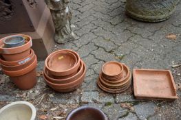 Terracotta plant pots with stands.