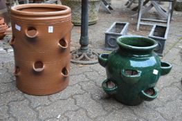 A large salt glazed terracotta strawberry planter and a similar glazed planter.